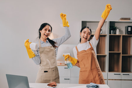 Female janitor with vacuum cleaner in roomの写真素材