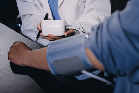 Close-up of doctor checking blood pressureの写真素材