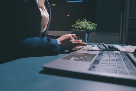 Expert woman asian female people review data number costing managerial account prepare monthly actual cost variance report at tax audit office. ESG sheet budget control ERP process service project.の写真素材