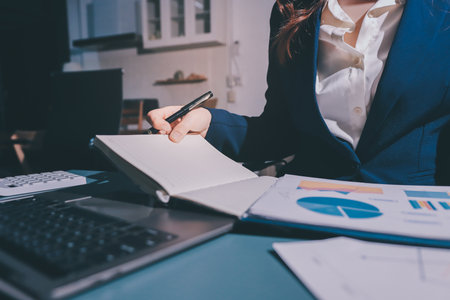 Expert woman asian female people review data number costing managerial account prepare monthly actual cost variance report at tax audit office. ESG sheet budget control ERP process service project.の写真素材
