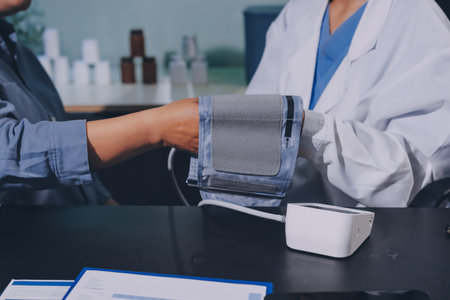Close-up of doctor checking blood pressureの写真素材