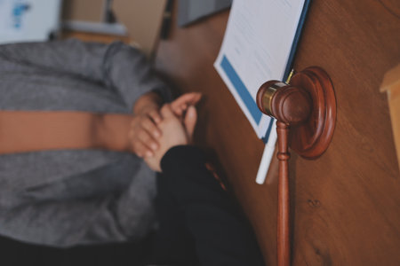 Judge gavel with Justice lawyers having team meeting at law firm background. Concepts of Law and Legal services.の写真素材