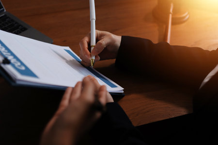 Judge gavel with Justice lawyers having team meeting at law firm background. Concepts of Law and Legal services.の写真素材