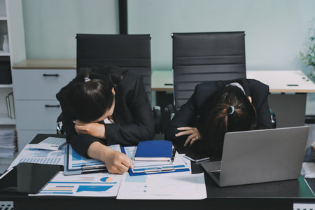 Asian women are stressed while working on laptop, Tired asian businesswoman with headache at office,...
