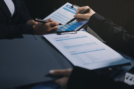 Teamwork with business people analysis cost graph on desk at meeting room. double exposure successful teamwork,business planning concept.の写真素材