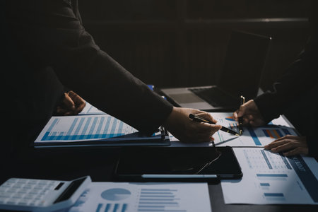 Teamwork with business people analysis cost graph on desk at meeting room. double exposure successful teamwork,business planning concept.の写真素材