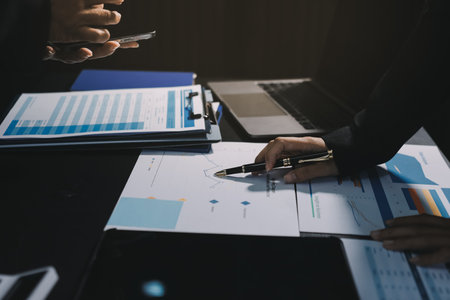 Teamwork with business people analysis cost graph on desk at meeting room. double exposure successful teamwork,business planning concept.の写真素材