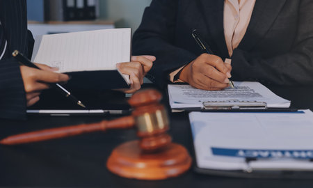 Judge gavel with Justice lawyers, Business woam in suit or lawyer working on a documents. Legal law, advice and justice concept.の写真素材
