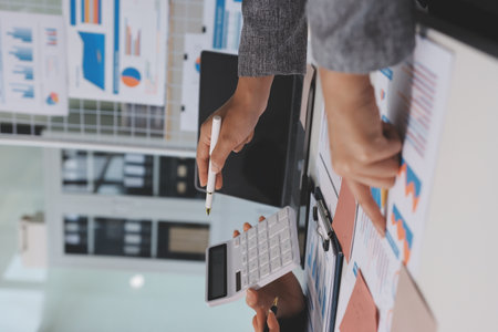 Accounting company provide finance and taxation planning for profitable cash flow, Auditor and accountant team working in office, analyze financial data and accounting record with calculator.Insightの写真素材