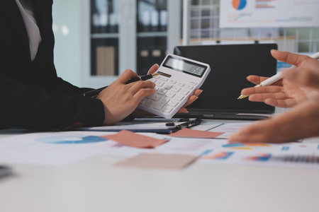 Accounting company provide finance and taxation planning for profitable cash flow, Auditor and accountant team working in office, analyze financial data and accounting record with calculator.Insightの写真素材