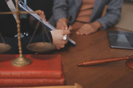 Judge gavel with Justice lawyers having team meeting at law firm background. Concepts of Law and Legal services.の写真素材