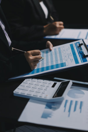 Teamwork with business people analysis cost graph on desk at meeting room. double exposure successful teamwork,business planning concept.の写真素材