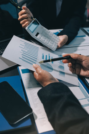 Teamwork with business people analysis cost graph on desk at meeting room. double exposure...