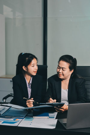 Entrepreneurs and business people in modern meeting room, happy multiracial coworkers have fun cooperating working together at office meeting, asian teamwork conceptの写真素材