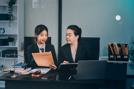 Judge gavel with Justice lawyers, Business woam in suit or lawyer working on a documents. Legal law, advice and justice concept.の写真素材