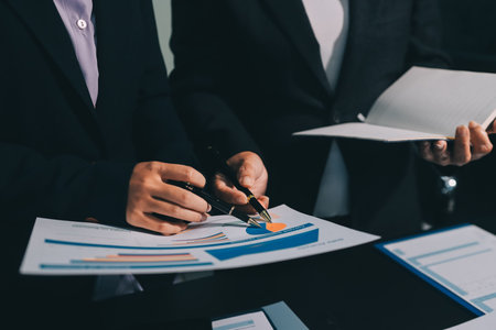 Teamwork with business people analysis cost graph on desk at meeting room. double exposure successful teamwork,business planning concept.の写真素材