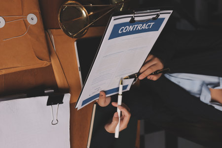 Attractive young lawyer in office Business woman and lawyers discussing contract papers with brass...