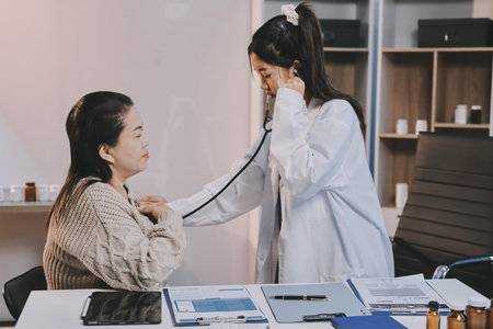 Doctor use stethoscope examining respiratory system and consultations for the elderly patients, talking check-up health or sharing test results, comforting and encourage. Concepts of medical treatment and specialists, health insurance, retirement.の写真素材