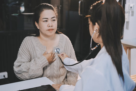 Doctor use stethoscope examining respiratory system and consultations for the elderly patients, talking check-up health or sharing test results, comforting and encourage. Concepts of medical treatment and specialists, health insurance, retirement.の写真素材