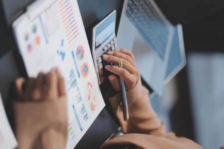 Business people team working at office with tablet and document, doing planning analyzing the financial report, business plan investment, finance analysis concept. Economic business discussions.の写真素材