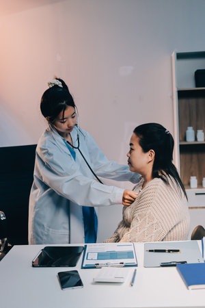 Doctor use stethoscope examining respiratory system and consultations for the elderly patients, talking check-up health or sharing test resultsの写真素材