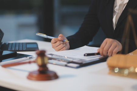 Judge gavel with Justice lawyers having team meeting at law firm background. Concepts of Law and...