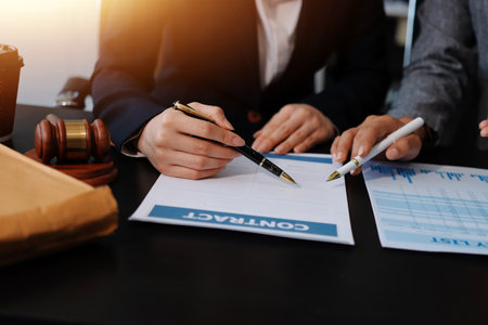 Gavel with Justice lawyers having team meeting at law firm background. Concepts of Law and Legal services.の写真素材