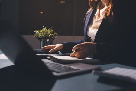 Expert woman asian female people review data number costing managerial account prepare monthly actual cost variance report at tax audit office. ESG sheet budget control ERP process service project.の写真素材