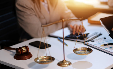 Consultation and conference of lawyers and professional businessman working and discussion having at law firm in office. Concepts of law, Judge gavel with scales of justice.の写真素材