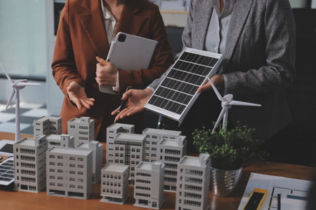 Discussion among businesspeople on the latest developments in solar cell panel technology and Solar Energy Environment city Concept.の写真素材
