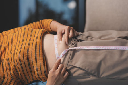 Cropped shot of woman touching her belly.の写真素材