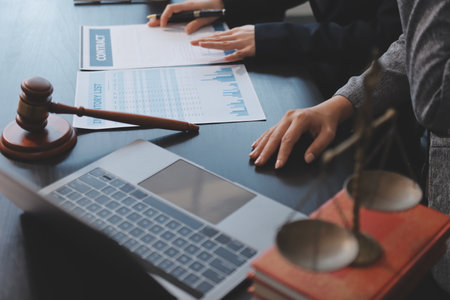 Judge gavel with Justice lawyers having team meeting at law firm background. Concepts of Law and Legal services.の写真素材