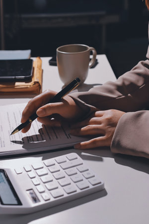 Female Real Estate Broker presenting and advised to model home and building project detail in the office, sign purchase sales contract, agreements concerned mortgage loan offer and insurance.の写真素材