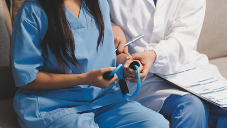 Unrecognizable uses blue hand weight during physical therapy sessionの写真素材