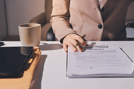 Female Real Estate Broker presenting and advised to 
model home and building project detail in the office, sign purchase sales contract, agreements concerned mortgage loan offer and insurance.の写真素材