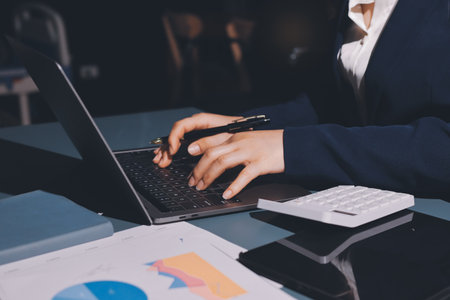 Expert woman asian female people review data number costing managerial account prepare monthly actual cost variance report at tax audit office. ESG sheet budget control ERP process service project.の写真素材