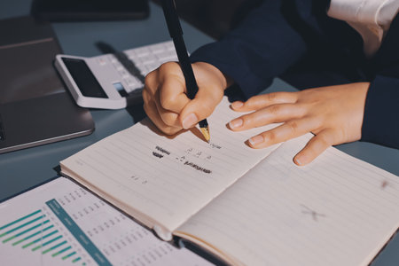 Expert woman asian female people review data number costing managerial account prepare monthly actual cost variance report at tax audit office. ESG sheet budget control ERP process service project.の写真素材