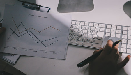 Expert woman asian female people review data number costing managerial account prepare monthly actual cost variance report at tax audit office. ESG sheet budget control ERP process service project.の写真素材