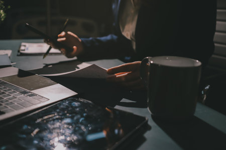Expert woman asian female people review data number costing managerial account prepare monthly actual cost variance report at tax audit office. ESG sheet budget control ERP process service project.の写真素材