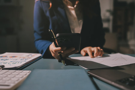 Expert woman asian female people review data number costing managerial account prepare monthly actual cost variance report at tax audit office. ESG sheet budget control ERP process service project.の写真素材