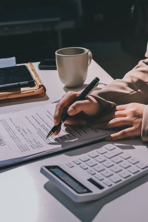 Female Real Estate Broker presenting and advised to 
model home and building project detail in the office, sign purchase sales contract, agreements concerned mortgage loan offer and insurance.の写真素材