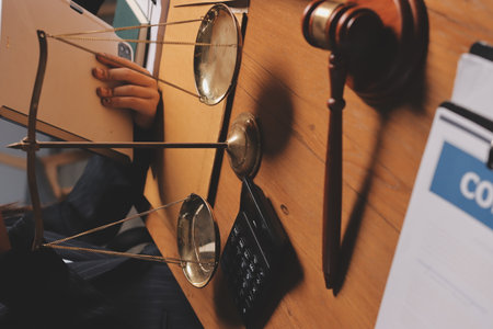 Attractive young lawyer in office Business woman and lawyers discussing contract papers with brass...