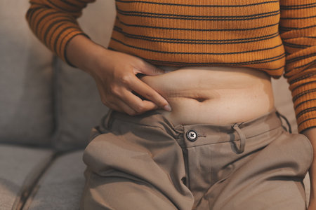 Cropped shot of woman touching her belly.の写真素材