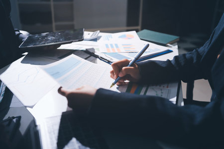 Group of business women working on a financial data expenses document.の写真素材