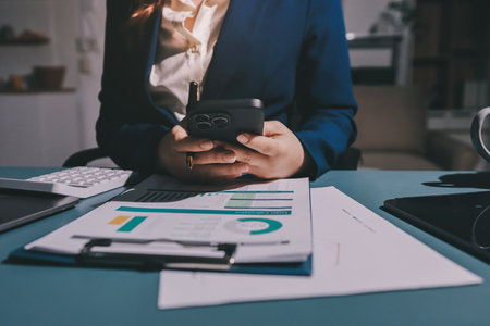 Expert woman asian female people review data number costing managerial account prepare monthly actual cost variance report at tax audit office. ESG sheet budget control ERP process service project.の写真素材