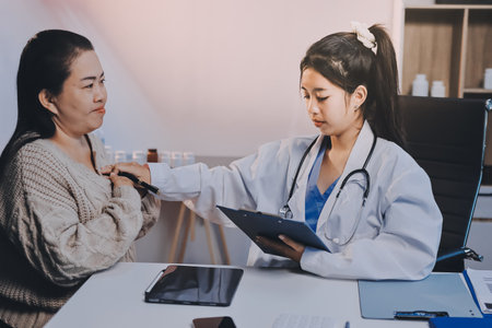 Doctor use stethoscope examining respiratory system and consultations for the elderly patients, talking check-up health or sharing test resultsの写真素材