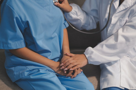 Close-up of doctor listening to a senior woman's heartbeat