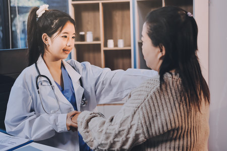 Medicine doctor hand reassuring her female patientの写真素材