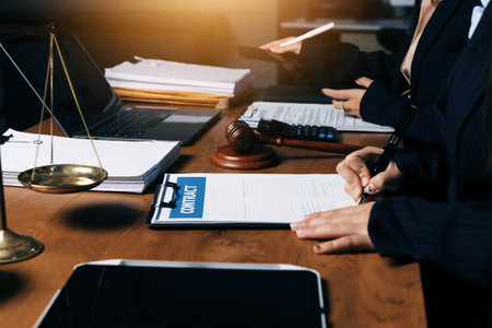 Attractive young lawyer in office Business woman and lawyers discussing contract papers with brass...