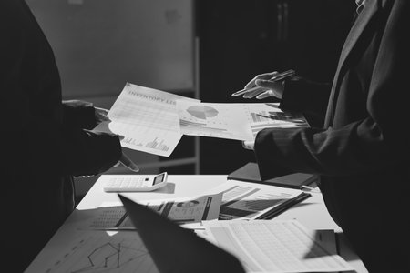 Group of business women working on a financial data expenses document.
